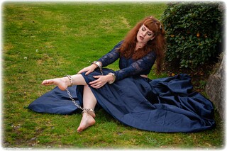 Bondage photo pic picture Zoe Page ballgag, ballgown, barefoot, handcuffs, leg irons, chains, metal bondage, outdoor, ungagged, redhead