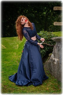 Bondage photo pic picture Zoe Page ballgag, ballgown, barefoot, handcuffs, leg irons, chains, metal bondage, outdoor, ungagged, redhead